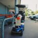 adorable dog on mobility scooter at supermarket