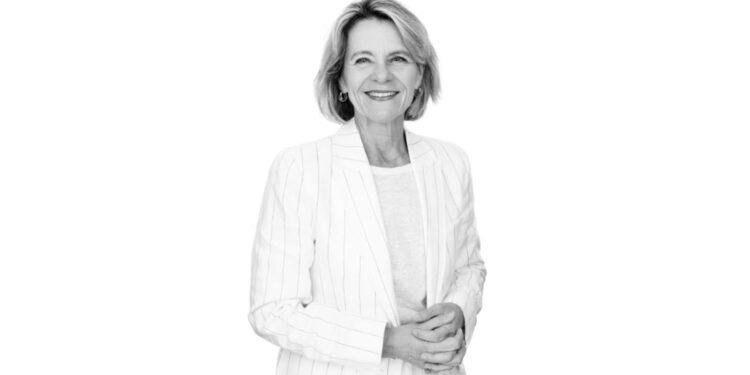Woman standing in front of white backdrop