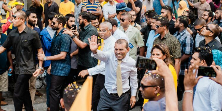man waving to the people