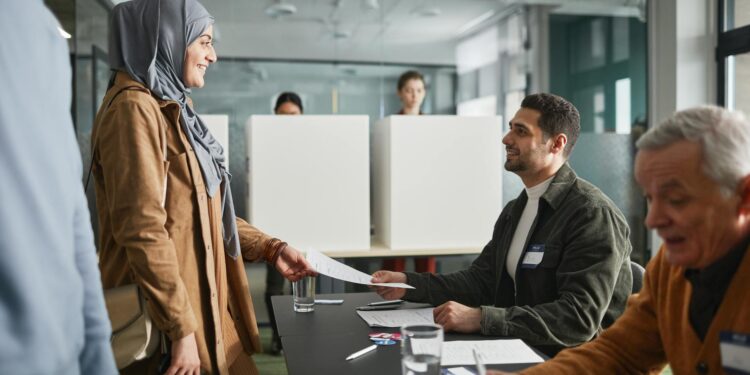 a man and a woman smiling while looking at each other