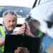 man assessing car