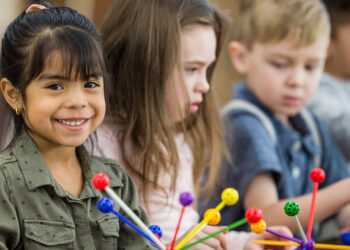 Child starting preschool with parent at orientation