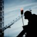 silhouette of man holding flamethrower