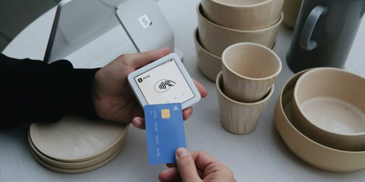 A person uses a credit card to pay.