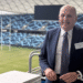 man with a football field in the background