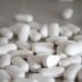white medication pills on brown surface