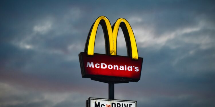 a mcdonald's sign with a cloudy sky in the background
