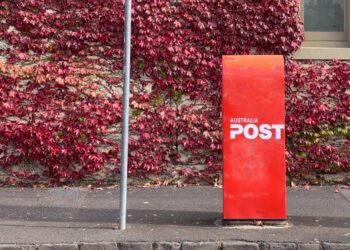 red postbox on sidewalk in australia