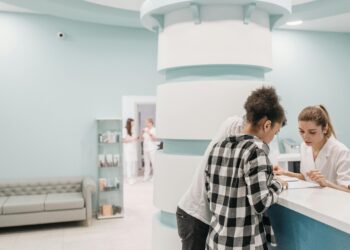two people signing into clinic