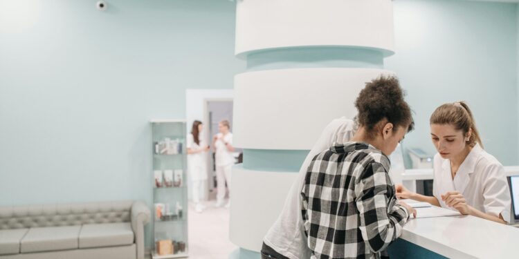 two people signing into clinic