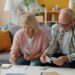 Elderly couple managing finances at home