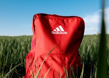 orange adidas backpack on grass field