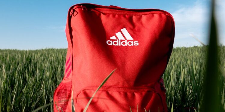 orange adidas backpack on grass field